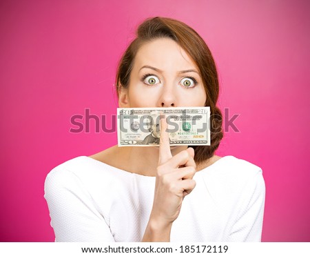 Closeup portrait young corrupt, secretive woman in white dress with twenty dollar bill taped to mouth, showing shhh sign, isolated magenta background. Bribery concept in politics, business, diplomacy