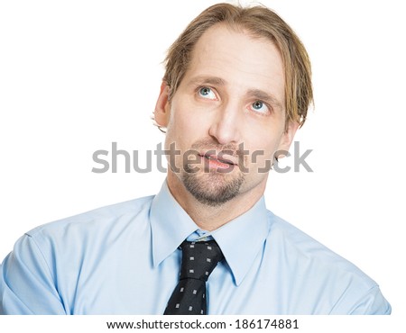 Closeup portrait, worried young man looking up, stressed, in deep thought, isolated white background. Negative human emotion, facial expression, feelings