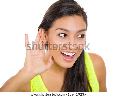Closeup portrait, young nosy woman secretly listening to conversation, hand to ear, happy surprised shocked at juicy gossip she hears, privacy violation, isolated white background. Great news.