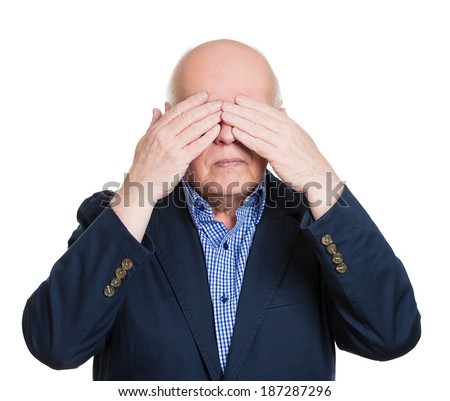 Closeup portrait, senior mature shy man closing covering eyes with hands can\'t see, hiding, isolated white background. See no evil concept. Negative human emotion facial expression feeling reaction
