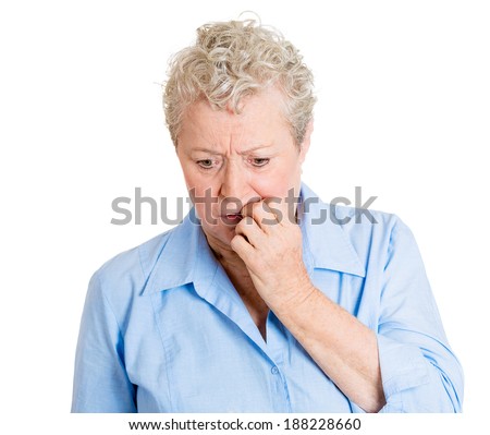 Closeup portrait, sad, alone, dark, gloomy, frustrated, stressed senior mature woman, biting finger, just realizing she made a serious, grievous error. Negative human emotion facial expression feeling