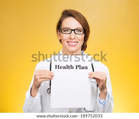 Closeup portrait, female health care professional, smiling, friendly doctor with stethoscope, holding a sign which says health plan and showing space for text, isolated yellow background. Obamacare