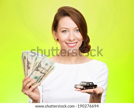 Closeup portrait, young business woman, bank agent, representative holding model black car, green dollar cash bills in hand, isolated green background.Lease offers, credit line, financing, dealership