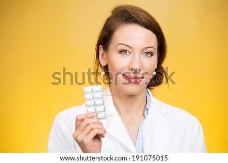 Closeup portrait smiling, health care professional, family doctor, endocrinologist, gynecologist, nutritionist, dentist holding, offering chewing gum, pills, vitamins. Female birth control methods