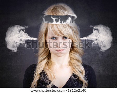 Closeup portrait angry, young woman, blowing steam coming out of ears, about to have nervous atomic breakdown, isolated black background. Negative human emotions, facial expressions, feelings attitude