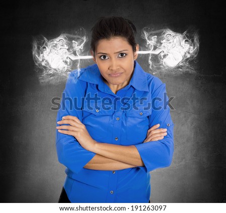 Closeup portrait angry young woman, blowing steam coming out of ears, about to have nervous atomic breakdown, isolated black background. Negative human emotions, facial expressions, feelings, attitude