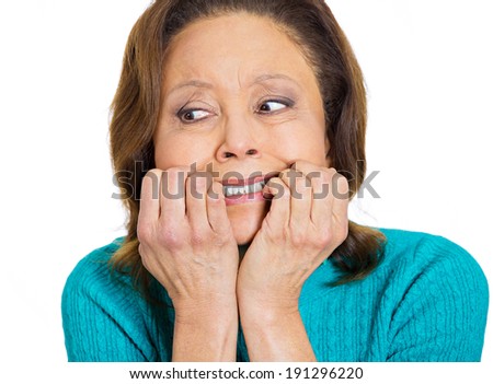 Closeup portrait, headshot, coy senior mature, old woman biting finger nails, stressed, craving something, scared isolated white background. Negative human emotions, face expression, feeling, reaction