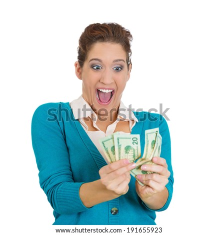 Closeup portrait super happy excited successful young woman holding money dollar bills in hand isolated white background. Positive emotion facial expression feeling reaction. Financial reward savings