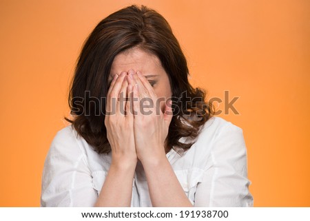 Closeup portrait sad depressed, stressed, thoughtful, middle age woman, gloomy, worried, looking confused, lost, isolated orange background. Human face expression emotion, feelings, reaction, attitude