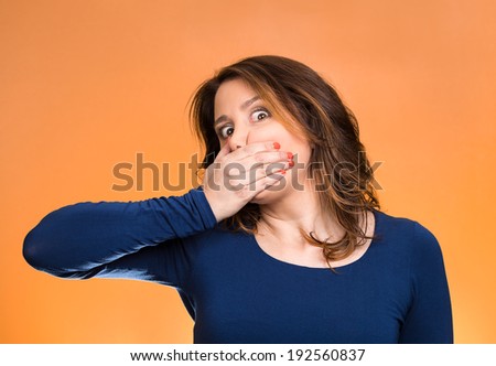 Closeup portrait middle aged business woman, worker, scared employee, covering mouth. Speak no evil concept, isolated orange background. Human emotions, face expression, feeling, sign, body language