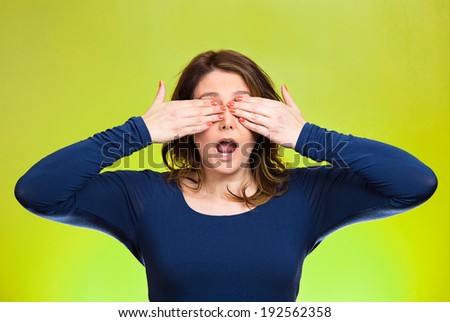 Closeup portrait, head shot young, coy woman, female closing eyes with hands can\'t see, hiding, mouth open, isolated green background. See no evil concept. Negative emotion, facial expression feeling