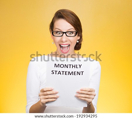 Closeup portrait happy excited young business woman looking at monthly statement glad to pay off bills, isolated yellow background. Positive emotions, facial expressions. Financial success, good news
