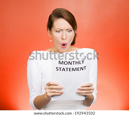 Closeup portrait shocked, funny looking business woman, disgusted at monthly statement, can\'t believe her eyes, isolated red background. Negative human emotion, facial expression, feeling. Bad news