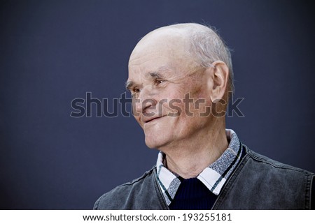 Closeup portrait, headshot happy, smiling mature, old man isolated blue background. Positive human emotions, facial expressions, reaction, life perception, attitude