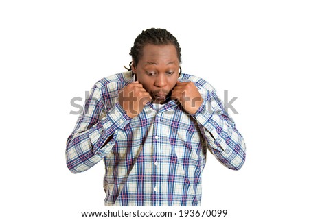 Closeup portrait, young funny looking man opening shirt to vent, blow air, it\'s hot, unpleasant awkward situation, embarrassment. Isolated white background. Negative emotion, facial expression feeling