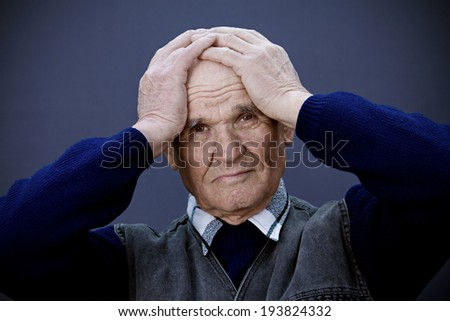 Closeup portrait, headshot senior, worried mature elderly man, old sad guy, grandfather, troubled, isolated dark blue background. Human emotions, facial expressions, life perception, aging, depression