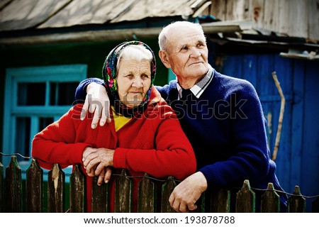 Closeup portrait happy, senior, elderly, old couple, grandmother, grandfather, pensioners on porch of country house, waiting, looking for kids. Human emotions, facial expressions, life perception