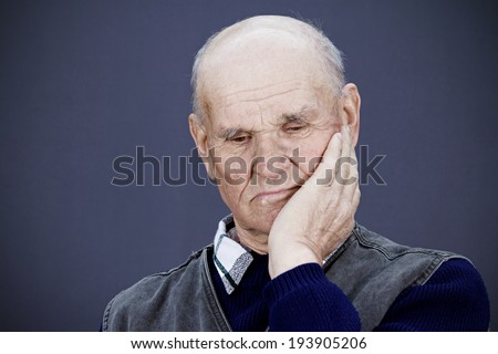 Closeup portrait senior, elderly, mature, sad depressed man, deep in thought, thinking, realizing truth, looking down isolated black background. Human face expressions, emotions, feeling, reaction