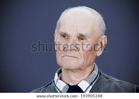 Closeup portrait, headshot senior, mature, elderly man, old sad guy, troubled, deep thought isolated black background. Human emotions, facial expressions, life perception aging, depression, loneliness