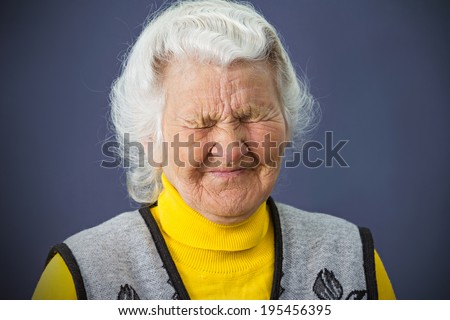 Closeup portrait, headshot, senior, elderly sad, depressed, lonely woman, grandmother crying, isolated dark blue background. Human facial expressions, emotions, reaction, life perception, mood
