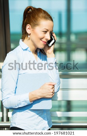 Closeup portrait business woman talking on mobile phone. Businesswoman on cellphone running while talking on smart phone. Happy smiling corporate employee isolated background office building windows