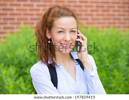 Closeup portrait businesswoman talking on mobile phone. Business woman, cellphone standing in front corporate office having conversation smartphone. Happy smiling employee isolated background building