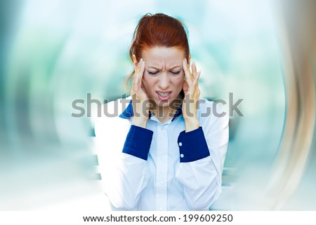 Closeup portrait sad unhappy young business woman, hands on head, bothered by mistake having bad headache isolated background corporate office. Negative human emotion, facial expression life reaction