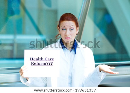 Closeup portrait female health care professional doctor with stethoscope holding sign health care reform? isolated hospital background. Obamacare, medicaid, legislation debate insurance plan coverage