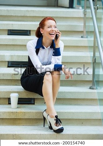 Portrait happy smiling businesswoman talking on mobile cell phone on her coffee break sitting outdoor. Business woman having conversation on cellphone isolated stairs background. Communication concept