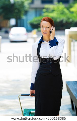 Portrait young urban happy businesswoman on smart phone running in street talking on smartphone smiling wearing jacket, carrying luggage bag on Washington DC streets USA. Corporate life travel concept