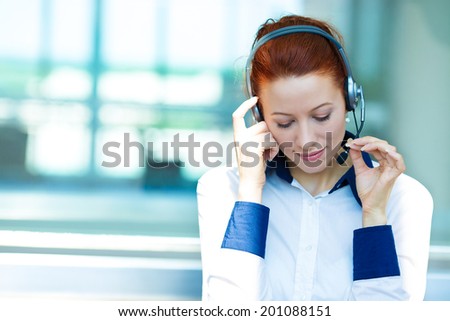Closeup portrait business woman, serious customer service representative call centre worker operator, support staff speaking with head set listening client problem isolated background corporate office