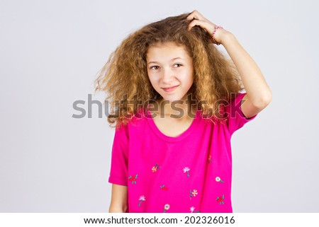 Closeup portrait young girl scratching head, thinking daydreaming deeply about something, looking up, isolated grey background. Human facial expressions, emotions, feeling, sign, symbol, body language