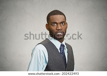 Closeup portrait shocked, stunned, surprised young business man fear in eyes, wide open, scared of something isolated black grey  background. Negative human emotion facial expression, feeling reaction