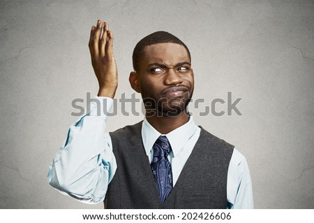 Closeup portrait, headshot dumb clueless young man, arms out asking what\'s problem who cares so what, I don\'t know. Isolated black grey background. Negative human emotions, facial expression, reaction