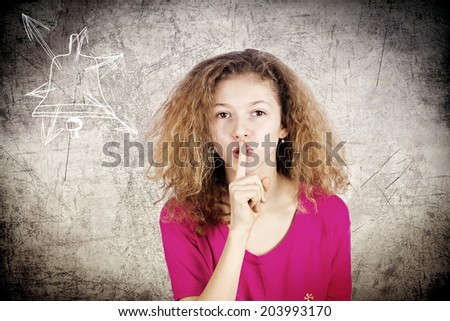 Secret girl. Closeup portrait young teenager showing hand silence sign, gesture finger on lips isolated black background. Human face expressions, body language, reaction, perception
