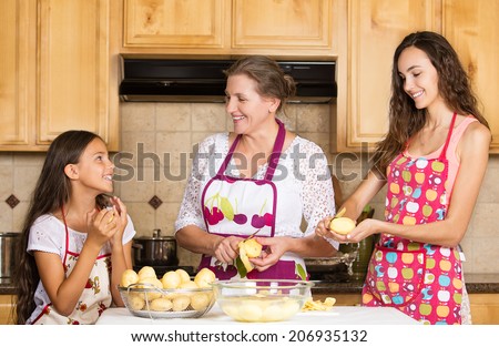 Group portrait of happy, smiling mother and daughter cooking dinner, preparing food isolated background home kitchen. Positive family emotions, face expression, life perception. Healthy eating concept