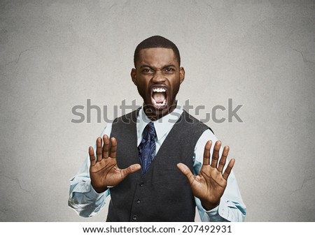 Closeup portrait furious angry annoyed displeased young man raising hands up to say no stop right there isolated grey background. Negative human emotion facial expression sign symbol body language
