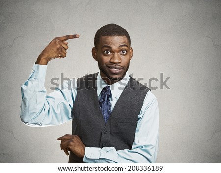 Closeup portrait rude difficult angry young executive businessman gesturing with finger against temple are you crazy? Isolated grey color background. Negative human emotion facial expression feeling