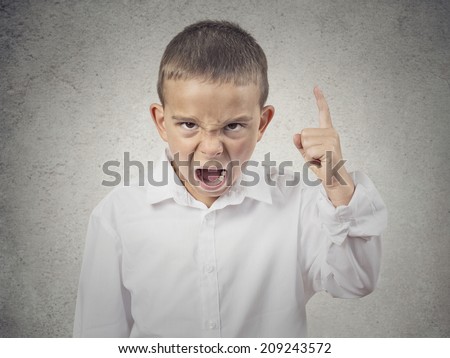 Closeup Portrait Angry child, Boy Screaming finger pointing up, demanding justice isolated grey wall background. Negative human Emotions, Facial Expressions, body language, attitude, perception