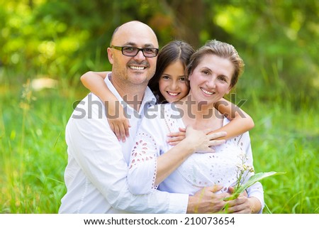 Group Portrait happy smiling family with one child outdoors nature on sunny summer day, park forest. Children parents, grandparents. Positive human emotion, facial expression, feeling, life perception