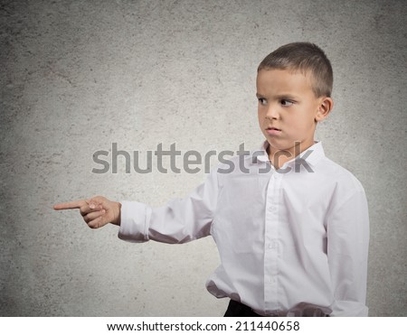 Closeup side view profile  portrait handsome young man, unhappy guy, looking angry, pointing with finger, blaming someone, isolated grey wall background. Negative human emotions, facial expressions