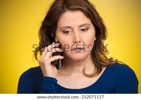 Young sad woman talking on mobile phone upset, depressed, unhappy, worried, isolated yellow background. Negative human emotions, facial expressions, feelings, life perception, reaction. Bad news