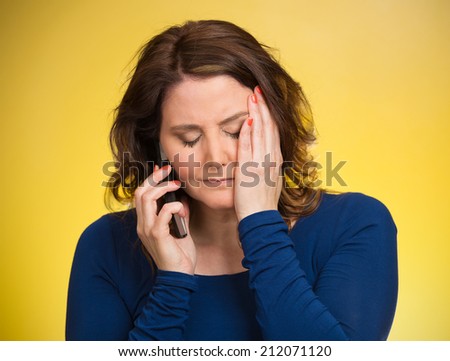Young sad woman talking on mobile phone upset, depressed, unhappy, worried, isolated yellow background. Negative human emotions, facial expressions, feelings, life perception, reaction. Bad news