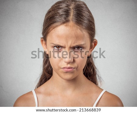 Closeup portrait angry young woman, unhappy teenager about to have nervous, atomic breakdown, isolated grey wall background. Negative human emotions, facial expressions, reaction, feelings, attitude