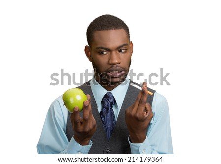 Stressed businessman deciding on healthy life choices, craving cigarette versus green apple isolated white background. Face expression, body language, bad, hazardous human habits