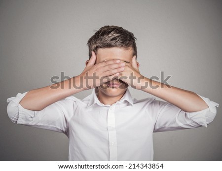Closeup portrait young male, shy man closing covering eyes with hands can\'t see, hiding, isolated grey wall background. See no evil concept. Negative human emotion, facial expression, feeling reaction