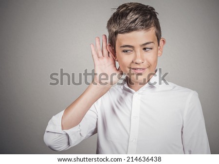 Portrait handsome man, guy secretly listening private conversation, surprise, hand to ear gesture, privacy violation concept isolated grey wall background. Human face expression feeling, body language