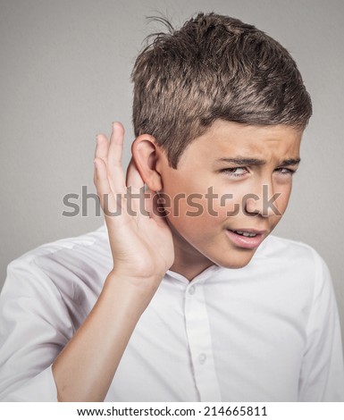 Closeup portrait unhappy hard of hearing man placing hand on ear asking someone speak up, listening to bad news isolated grey wall background. Negative emotion facial expression feeling body language