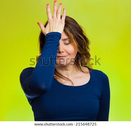 Portrait sad middle aged woman realizes mistake, regrets, slapping hand on head to say duh, isolated green background. Negative emotions, facial expression, feelings, body language, reaction