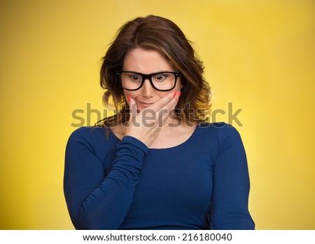 Awkward situation. Portrait embarrassed woman anxiously thinking how to get out of this, isolated yellow background. Human face expressions, emotions, feelings, reaction, life perception